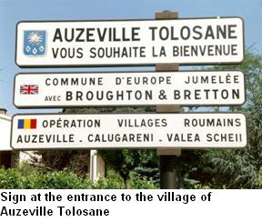 sign reading auzeville tolosane and underneath a sign in french saying they are twinned with Broughton & Bretton